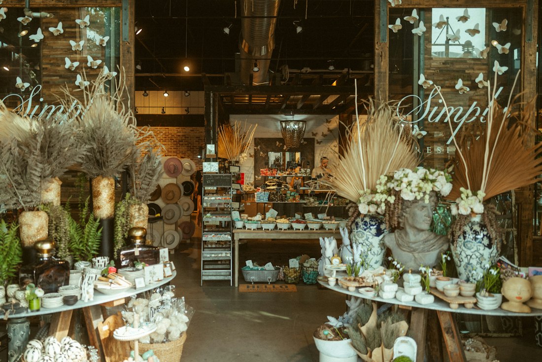 A shop owner standing in their store