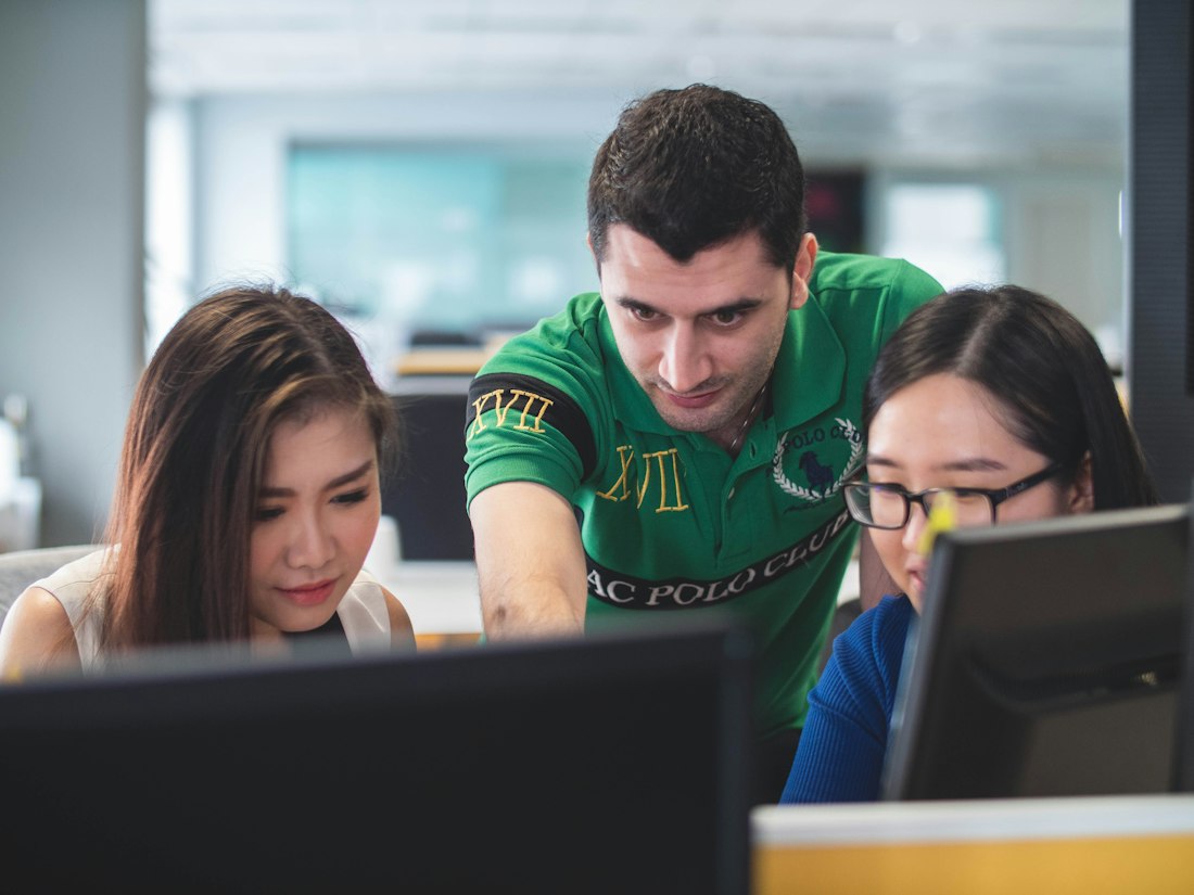 Students working together around a laptop